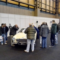 Courntey cleaning Saint car with crowd